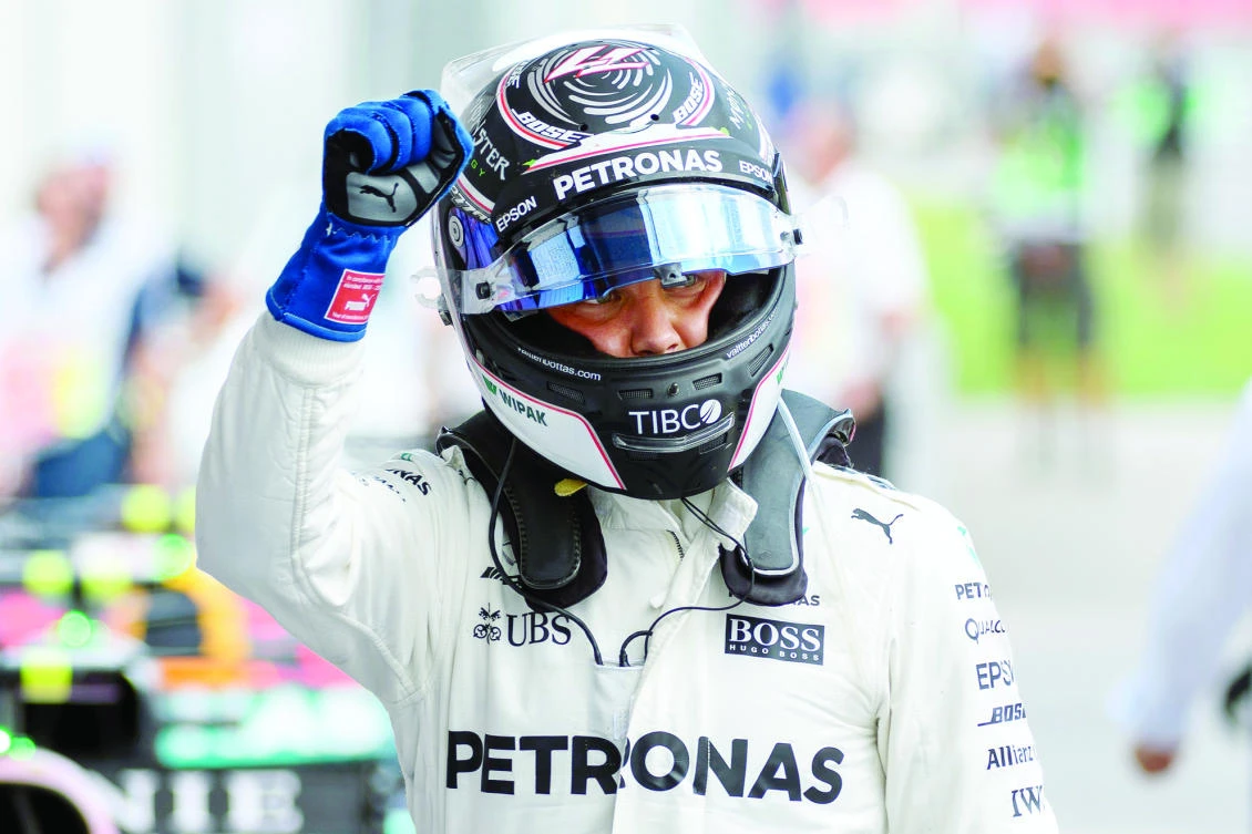 Mercedes’ Finnish driver Valtteri Bottas celebrates after winning the pole position during the qualifying session of the Formula One Austria Grand Prix at the Red Bull Ring in Spielberg on Saturday. (AFP)