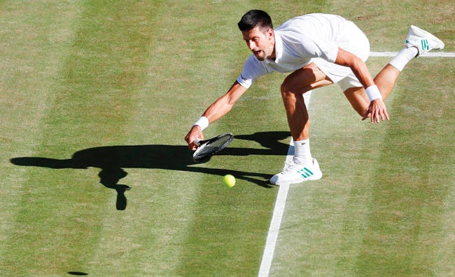 Serbia's Novak Djokovic returns against Latvia's Ernests Gulbis during their men's singles third round match on the sixth day of the 2017 Wimbledon Championships at The All England Lawn Tennis Club in Wimbledon, southwest London, on Saturday. (AFP)