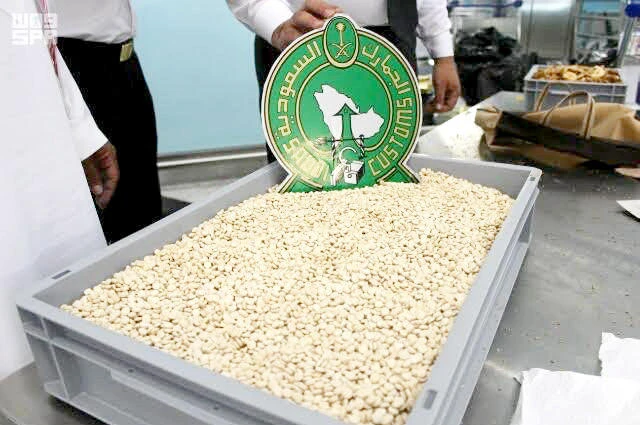 Saudi Customs officers display confiscated drugs hidden in a passenger’s luggage. (SPA)