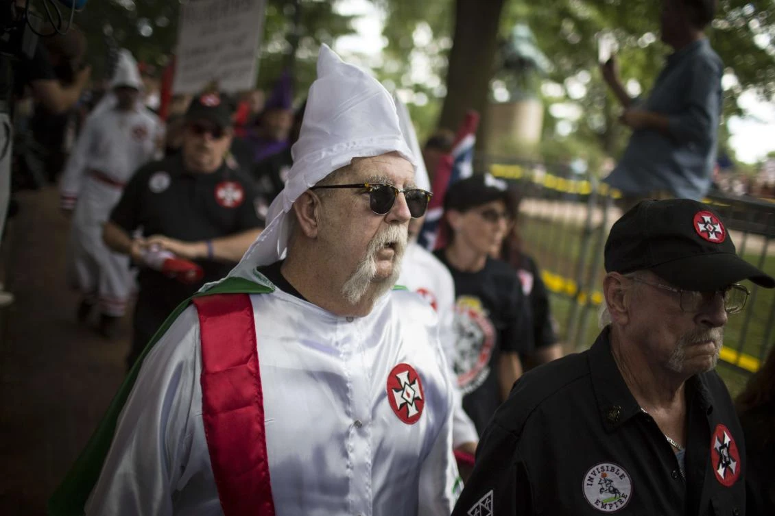 A Ku Klux Klan member is escorted out of Justice Park after a planned protest by the Klan on July 8, 2017 in Charlottesville, Virginia. (Getty Images/AFP)