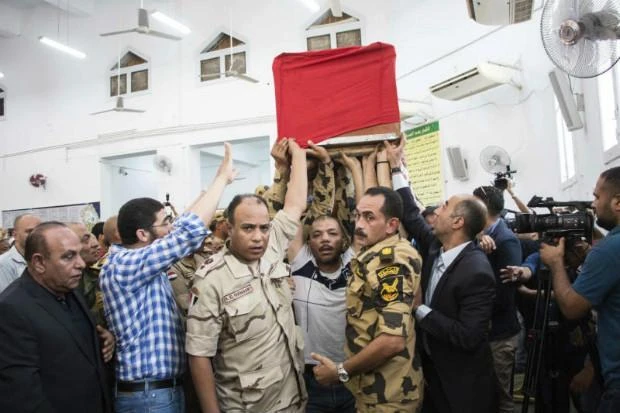 Men carry the coffin of a soldier, who was killed a day earlier in the restive Sinai Peninsula, during a funeral ceremony in the 10th of Ramadan city, about 60kms north of Cairo, on Saturday. The Islamic State group claimed responsibility for attacking a remote Egyptian army outpost in the Sinai Peninsula with a suicide car bomb and heavy machine gun fire. The assault killed at least 23 soldiers in the deadliest attack in the turbulent region in two years. (AP)