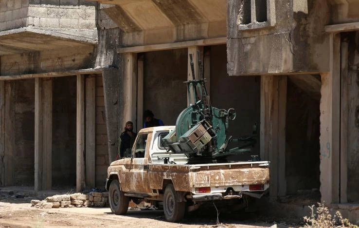 Free Syrian Army fighter stand near an anti-air craft machine gun in Quneitra, Syria July 8, 2017. (REUTERS)