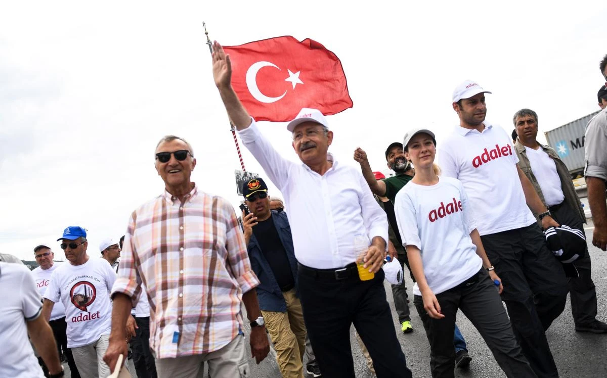 Republican People's Party (CHP) leader Kemal Kilicdaroglu (C) waves as he walks with thousands of supporters in Izmit on July 5, 2017, on the 21st day of a three-week "march for justice" from Ankara to Istanbul. Kilicdaroglu began the march on June 15 after former journalist turned CHP lawmaker Enis Berberoglu was sentenced to 25 years in jail on charges of leaking classified information to a newspaper. (AFP)