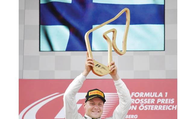 Mercedes’ Finnish driver Valtteri Bottas celebrates on the podium after winning the Formula One Austria Grand Prix at the Red Bull Ring in Spielberg on Sunday. (AFP)
