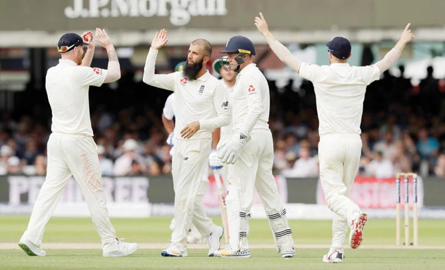 England’s Moeen Ali, second left, celebrates taking the wicket of South Africa’s Theunis de Bruyn during the first test between England and South Africa at Lord's cricket ground in London Sunday. (AP)