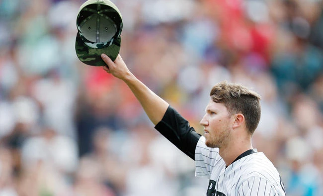 Colorado Rockies pitcher Kyle Freeland acknowledges the applause of the crowd as he heads to the dugout after being pulled from the mound when his no-hit bid was broken by a single off the bat of Chicago White Sox Melky Cabrera with one out in the ninth inning of a baseball game Sunday in Denver. The Rockies won 10-0. (AP)