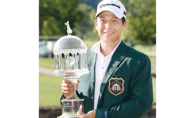 Xander Schauffele holds the champion trophy on the 18th green after winning the Greenbrier Classic PGA Tour golf tournament Sunday in White Sulphur Springs, West Virginia. (AP)