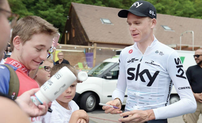 Great Britain’s Christopher Froome of Team Sky signs autographs as he meets fans before a training session during the first day off of the 104th edition of the Tour de France cycling race on Monday in Trelissac, near Perigueux, central France. (AFP)