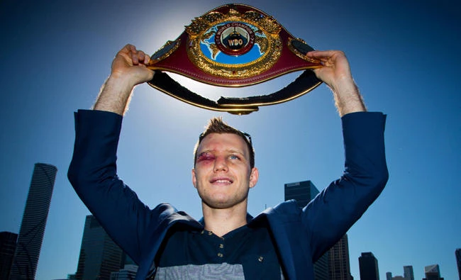 This file photo taken on July 3, 2017 shows newly crowned World Boxing Organization welterweight champion Jeff Horn of Australia posing for photographs with his belt after a press conference in Brisbane, one day after he beat Manny Pacquiao of the Philippines. (AFP/PATRICK HAMILTON)