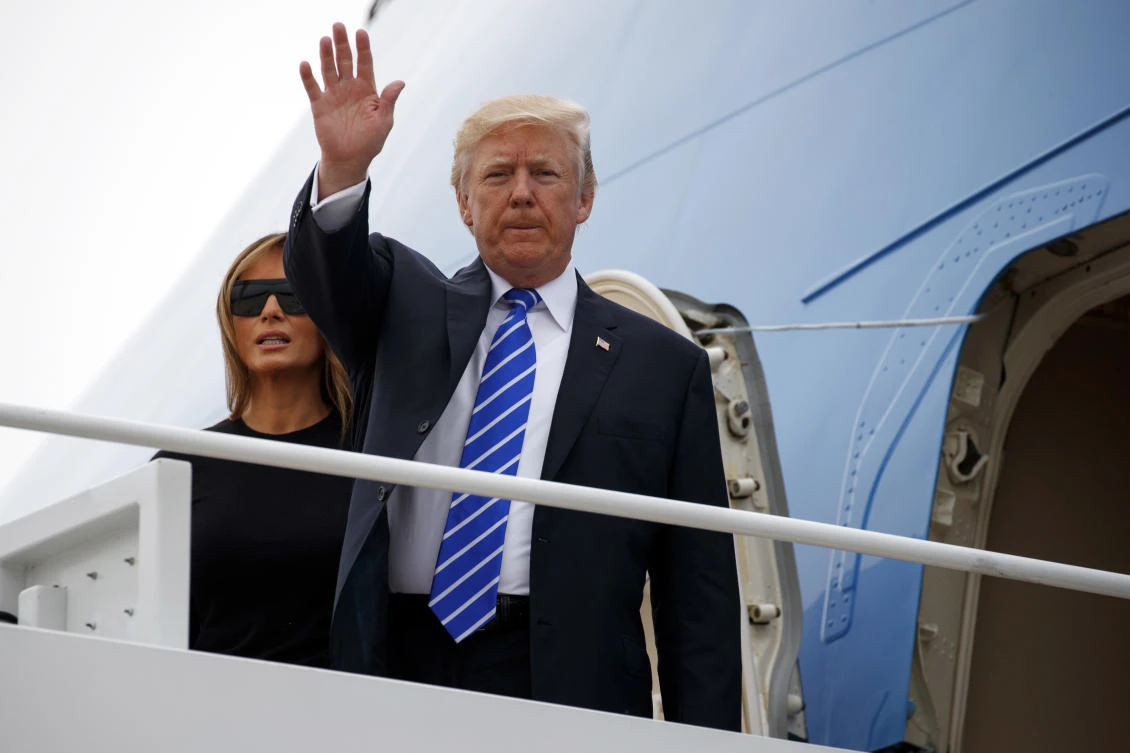 President Donald Trump waves as he boards Air Force One with first lady Melania Trump for a trip to Poland and Germany, Wednesday, July 5, 2017, at Andrews Air Force Base, Md. (AP)