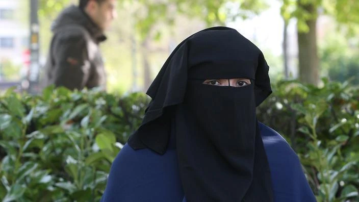 FILE - A woman wears the niqab as she sits in a park in Brussels in 2010. (AP)