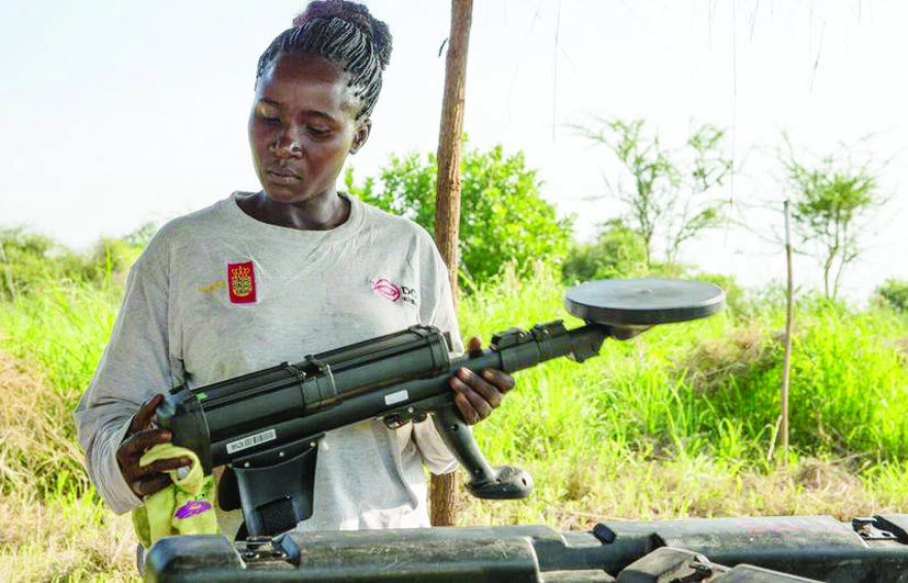 Angaika Benjamin is cleaning her metal detector before starting her work in Kolye, South Sudan, in this July 6 photo. (Reuters)