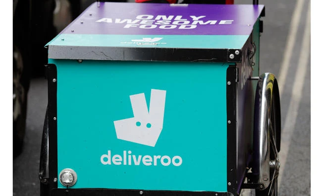 A deliveroo logo on a bicycle in London on Tuesday. A former adviser to Tony Blair is unveiling a much-anticipated report on the so-called gig economy, and has advised additional protection for workers in facing of vanishing job security. Unions and employment lawyers have criticized the report, saying it offered a feeble response to the growing number of workers in delivery and taxi firms such as Deliveroo and Uber. (AP Photo/Frank Augstein)