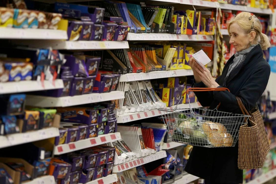British households spent more money on food and other essentials last month but held back on less urgent purchases as they faced rising prices. (Reuters)