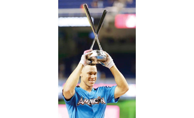 New York Yankees' Aaron Judge with the trophy after winning the MLB All-Star Home Run Derby Monday in Miami. (AP)