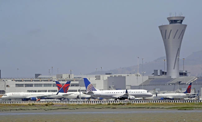 Departing and parked aircraft intersect at San Francisco International Airport on Tuesday in San Francisco, California. (AP Photo/Marcio Jose Sanchez)