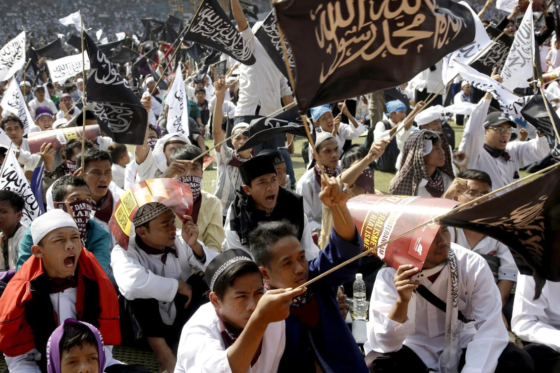 FILE - In this Saturday, May 30, 2015, file photo, members of Hizbut Tahrir Indonesia shout slogans during a rally in Jakarta, Indonesia. Indonesia's president has signed a decree giving the government the power to ban radical organizations in a move aimed at outlawing groups behind an apparent rise in the political clout of hard-line Islam. It is likely that Hizbut Tahir, a group that campaigns for Indonesia to adopt Shariah law and become a caliphate, is among the targets of the decree after the government announced in May that it planned to ban the group. (AP)
