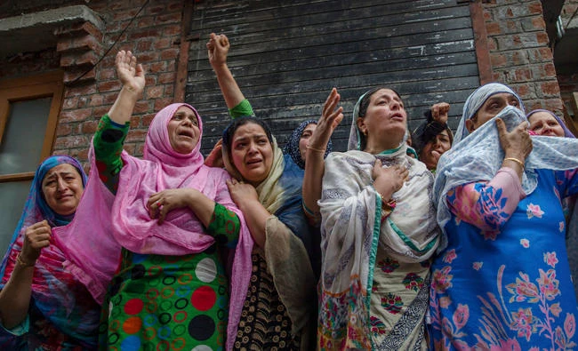 Kashmiri women wails as they watch the funeral procession of a local rebel Sajad Ahmed Gilkar, in Srinagar on Wednesday. (AP)
