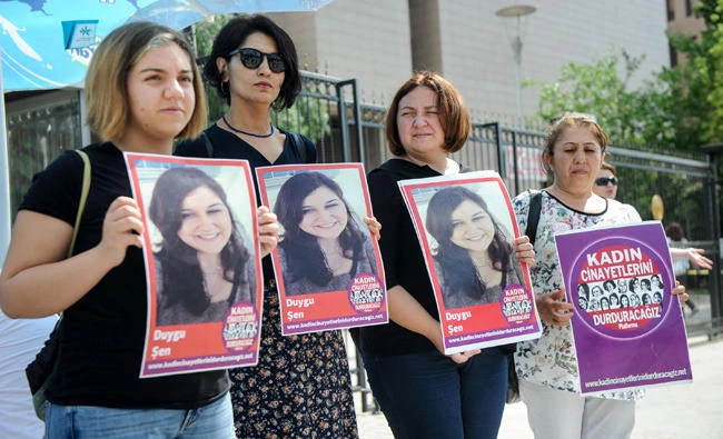 Women hold a portrait of a victim during a demonstration in front of the courthouse in Izmir, Turkey, in this file photo. (AFP)