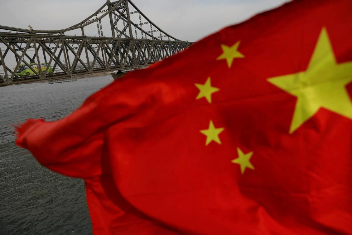 A Chinese flag flies near the Friendship bridge connecting the North Korean town of Sinuiju and Dandong in China’s Liaoning province. (Reuters)