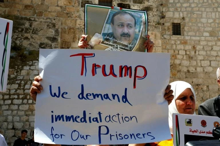 Palestinians protest outside Bethlehem's Church of the Nativity in support of hunger-striking prisoners in Israeli jails during Trump's visit to the West Bank town in May. (AFP)