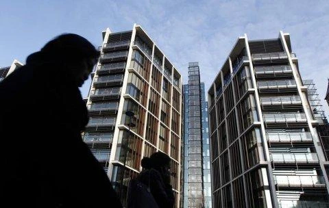 Pedestrians pass new development One Hyde Park in London. (Reuters)