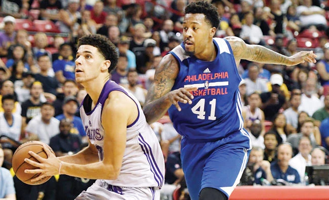 Lonzo Ball of the Los Angeles Lakers drives to the basket against Isaiah Miles of the Philadelphia 76ers during the 2017 Summer League at the Thomas & Mack Center on Wednesday in Las Vegas, Nevada. Los Angeles won 103-102. (AFP)