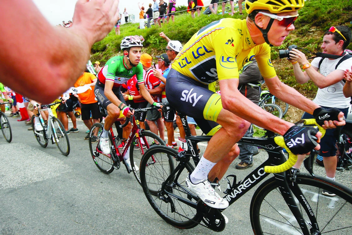 Britain's Chris Froome, right, and new overall leader Fabio Aru of Italy, center, climb Peyresourde pass, during the 12th stage of the Tour de France cycling race over 214.5 kilometers (133.3 miles) with start in Pau and finish in Peyragudes, France, Thursday. (AP)
