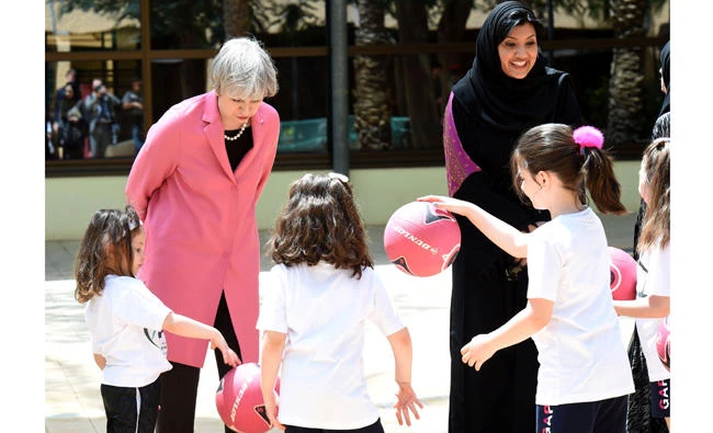 In this April 5, 2017 photo, British Prime Minister Theresa May and the Saudi head of the women's section at the general authority for sports, Princess Reema Bint Bandar Al-Saud, chat with Saudi girls during a basketball class at Olympic headquarters in Riyadh. The Education Ministry on Tuesday said state schools for girls would offer physical education from the next academic year providing they had the facilities. (Reuters file photo)