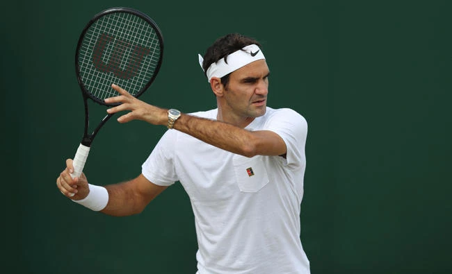 Switzerland's Roger Federer plays a shot as he attends a practice session at The All England Lawn Tennis Club in Wimbledon, London, on July 13, 2017 on the eve of his semi-final match against Czech Republic's Tomas Berdych. (AFP)