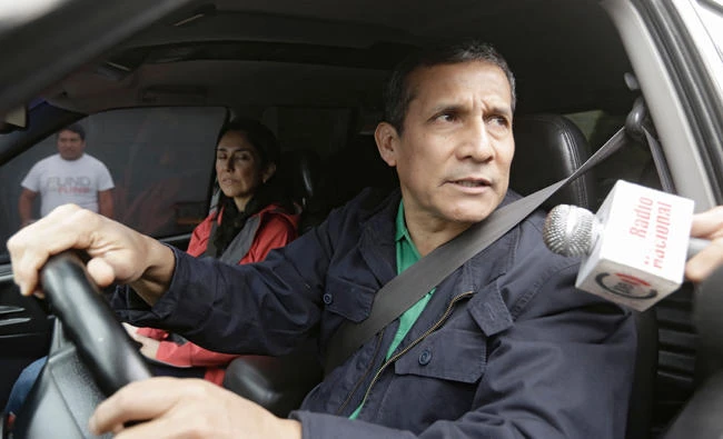 Peruvian former president Ollanta Humala speaks to the press as he leaves his home next to his wife Nadine Heredia in Lima on July 13, 2017. (AFP)