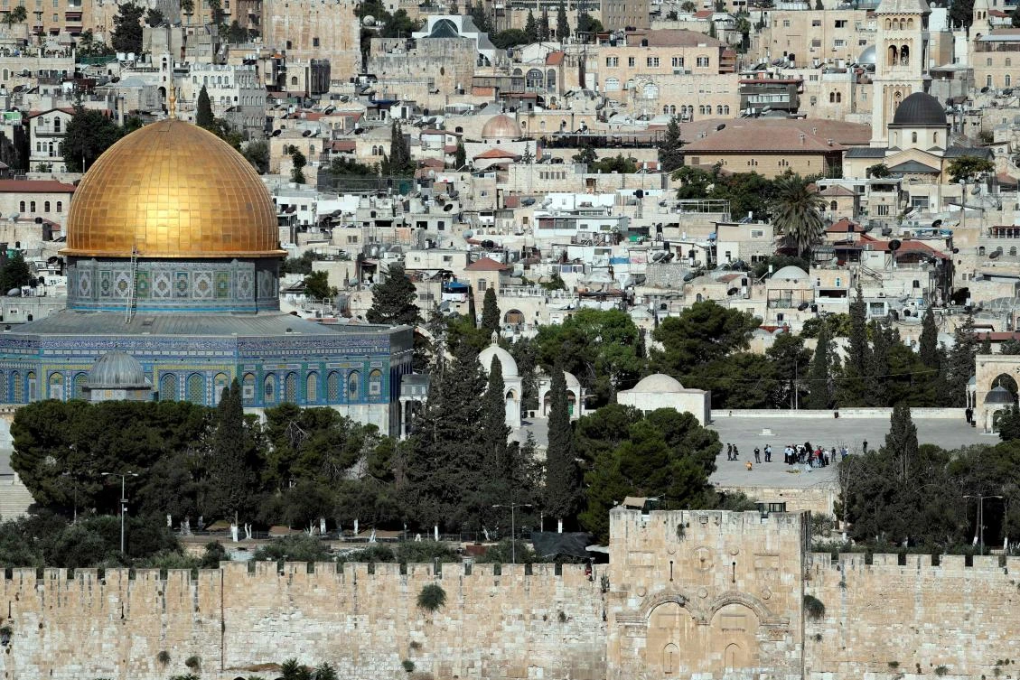 Israeli police check the scene (center R) and surround a dead body where assailants fired shots toward Israeli forces on the Al Aqsa mosque compound in the Jerusalem’s Old City on July 14, 2017. (AFP)