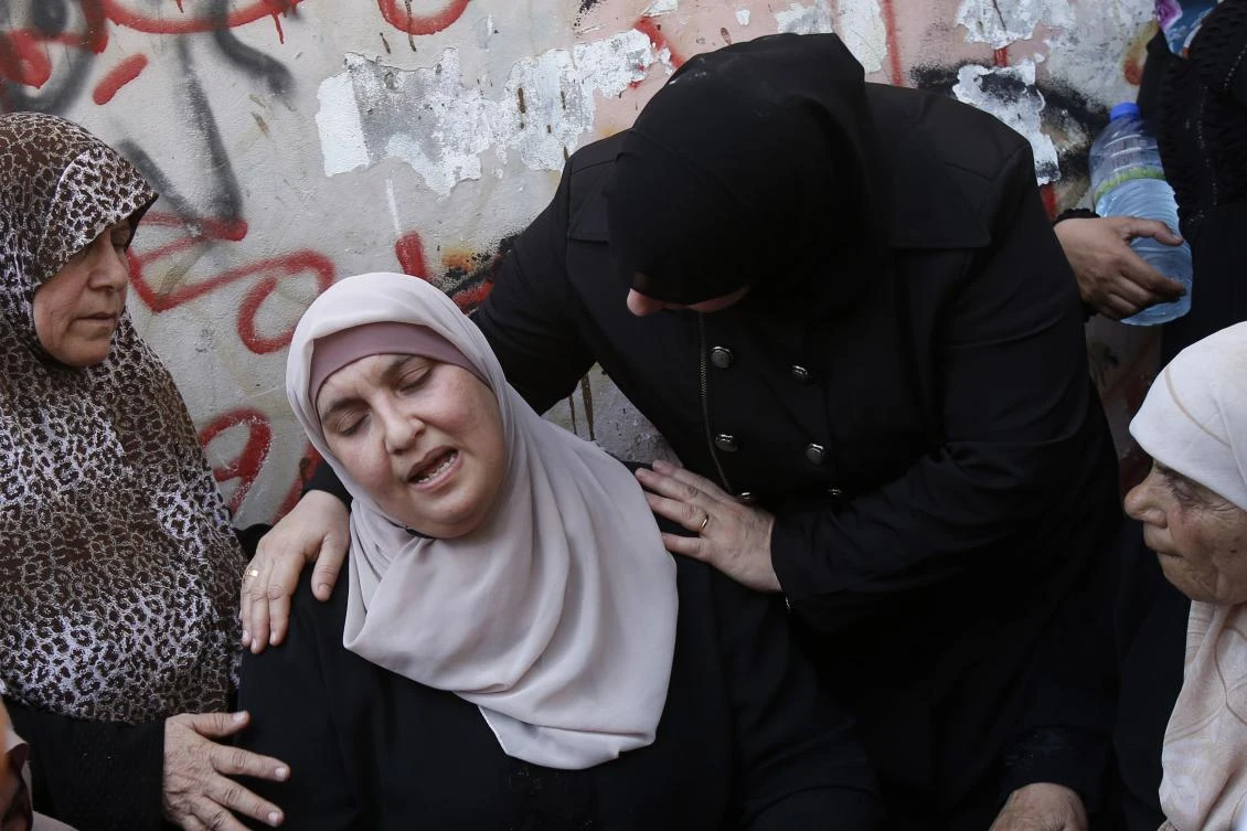 The mother of Palestinian Bara Hamamdah cries during his funeral in the Dheisheh Refugee Camp, near Bethlehem, on Friday. (AFP)