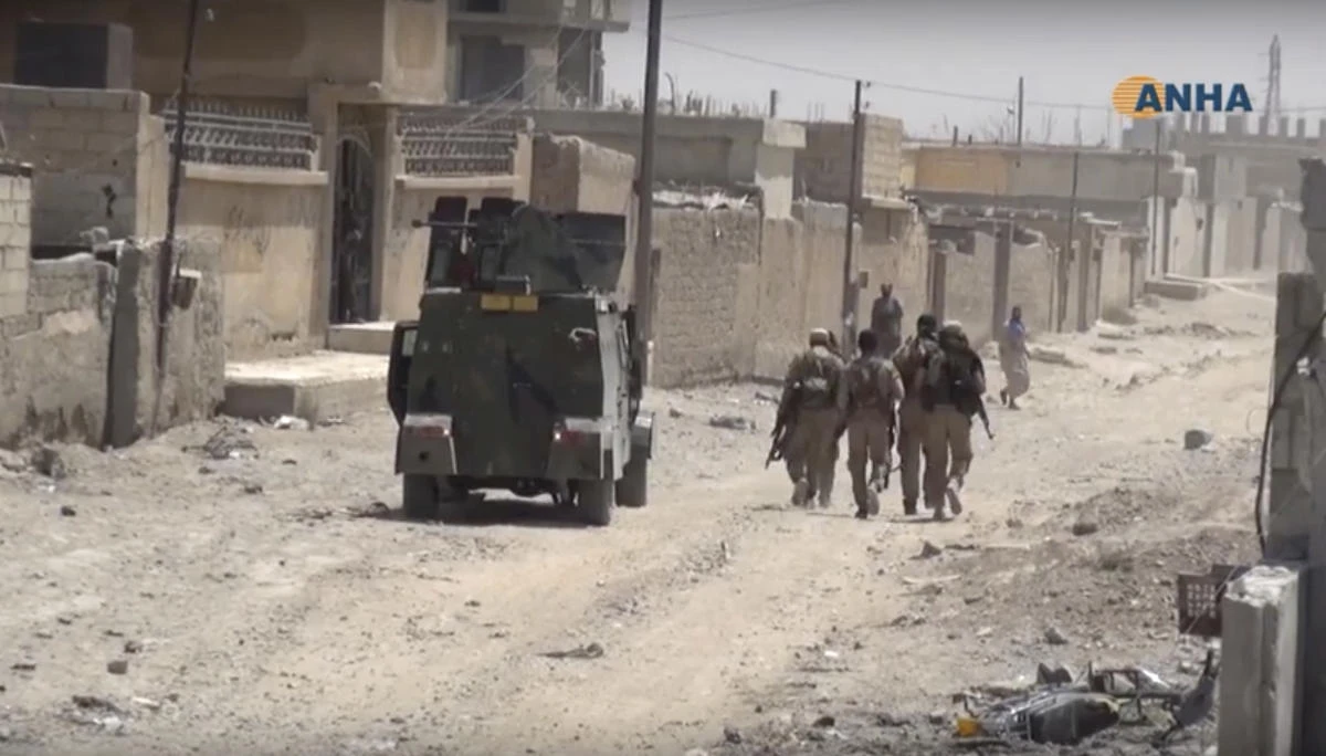 This frame grab from video released Thursday, July 6, 2017 and provided by Hawar News Agency, a Syrian Kurdish activist-run media group, shows U.S.-backed Syrian Democratic Forces (SDF) fighters in the eastern side of Raqqa, Syria. (Hawar News Agency, via AP)