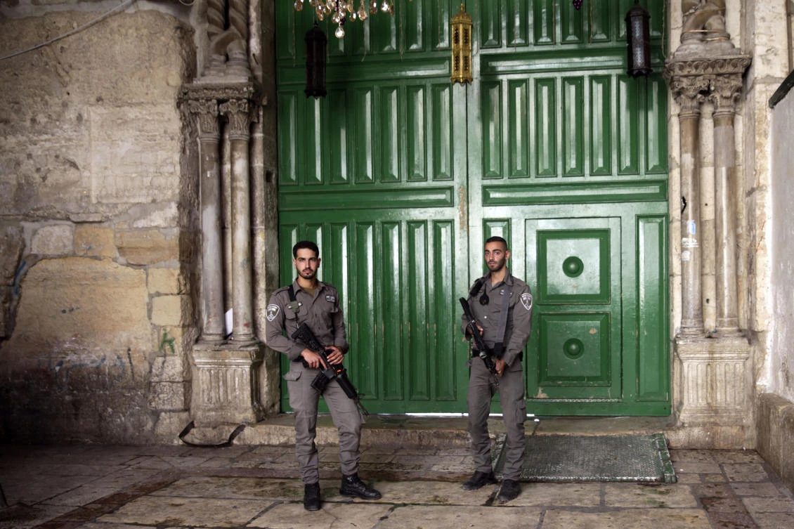 Israeli border police officers stand guard at the entrance to the Al-Aqsa Mosque compound in Jerusalem's Old City. (AP Photo/Mahmoud Illean)
