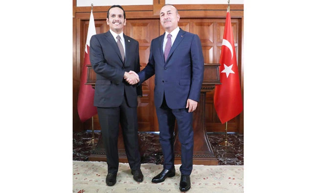 Turkish Foreign Minister Mevlut Cavusoglu, right, with his Qatari counterpart Mohammed bin Abdulrahman Al-Thani after a joint press conference in Ankara on Friday. (AFP)