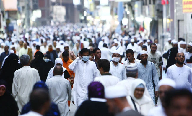 Muslims wearing masks walk outside the Grand Mosque after night prayer in Makkah in this file photo. The World Health Organization has said Saudi Arabia is well prepared to handle any infectious disease during the Haj season. (Reuters file photo)