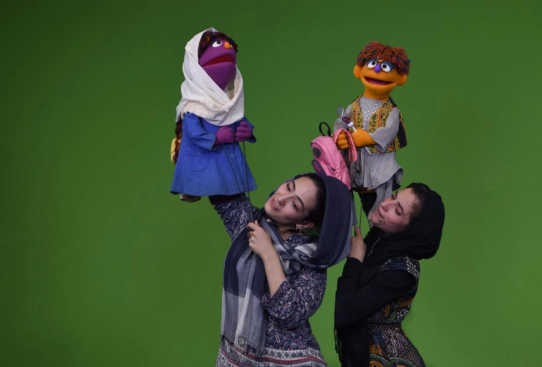 In this photograph taken on July 2, 2017, Afghan puppeteers hold new Sesame Street Muppets 'Zeerak' and 'Zari'. (AFP)