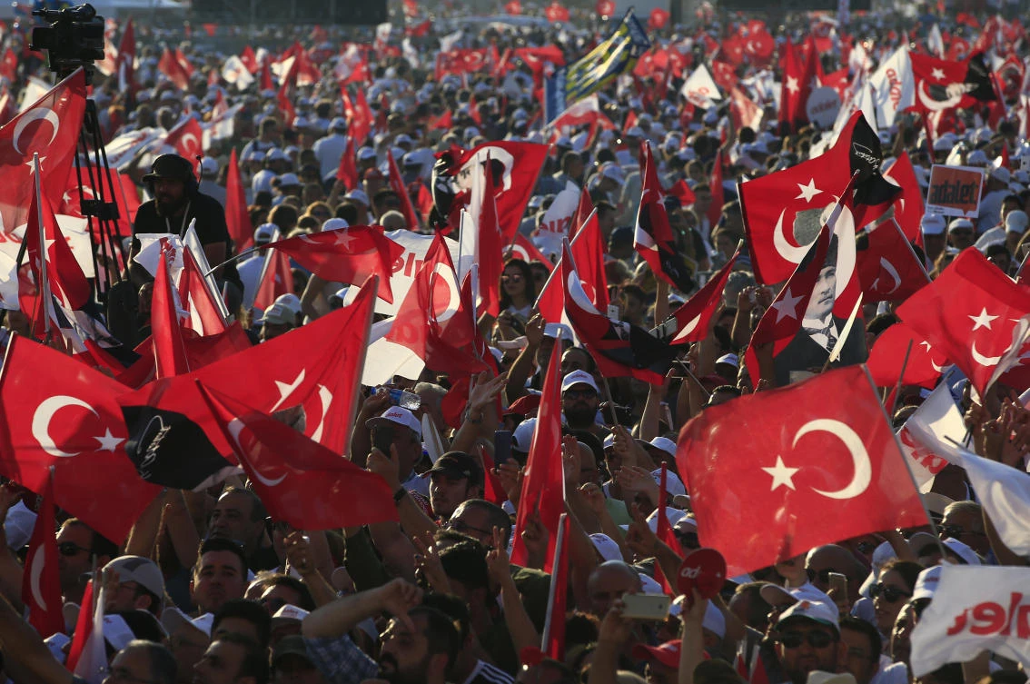 FILE - In this Sunday, July 9, 2017 file photo, supporters of Kemal Kilicdaroglu, the leader of Turkey's main opposition Republican People's Party, hold Turkish flags in Istanbul, as they gather for a rally following their 425-kilometer (265-mile) 'March for Justice' from capital Ankara to Istanbul. Turkey was roiled by the July 15, 2016 attempted coup against Turkey's President Recep Tayyip Erdogan, followed by a state of emergency, mass arrests and a wide-scale crackdown on civil servants including teachers. (AP)