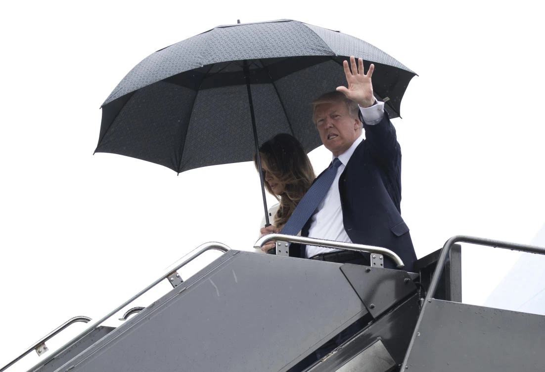 President Donald Trump, accompanied by first lady Melania Trump, waves as they arrive on Air Force One at Newark Liberty International Airport in Newark N.J., Friday, July 14, 2017 (AP Photo/Carolyn Kaster)
