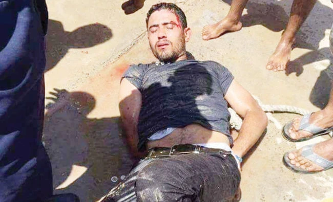 Workers and security personnel detain the man who stabbed two German tourists to death and wounded four others during an attack at the Zahabia hotel resort in Hurghada on Friday. (Reuters)