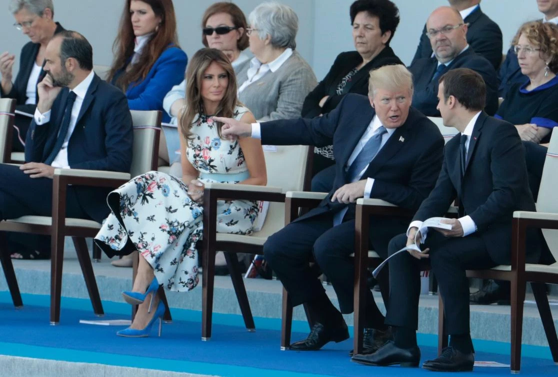 French President Emmanuel Macron (R) listens to US President Donald Trump (C) next to US First Lady Melania Trump (L) during the annual Bastille Day military parade on the Champs-Elysees avenue in Paris on July 14, 2017. (AFP)