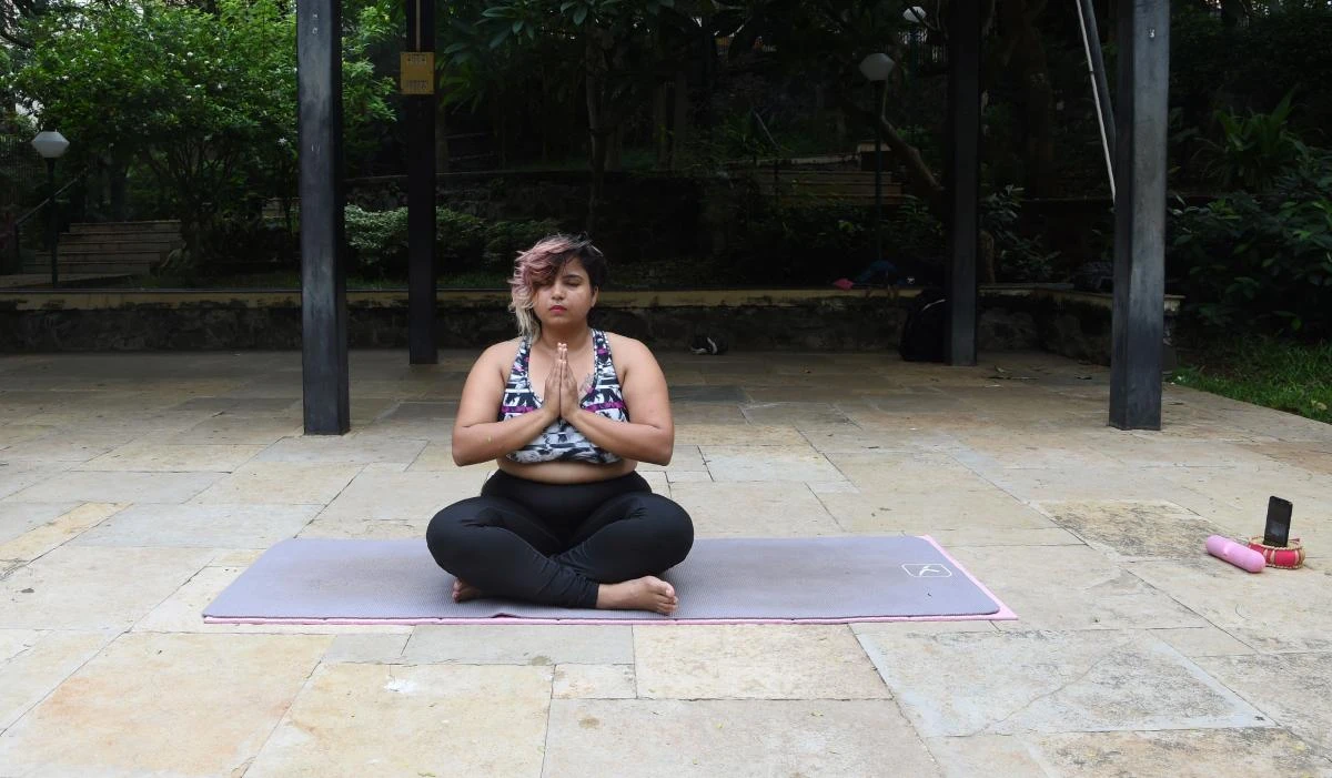 This photo taken on July 6, 2017 shows Dolly Singh, 34, doing yoga at a park in Mumbai. The plus-sized Indian woman is challenging body stereotypes and defying internet trolls with a series of yoga videos that are proving a hit on social media. (AFP)