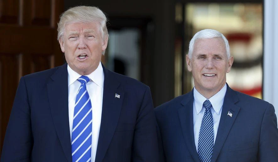 President-elect Donald Trump and Vice President-elect Mike Pence pause for photographs as they arrive at the Trump National Golf Club Bedminster clubhouse in Bedminster, N.J., Saturday, Nov. 19, 2016. (AP)