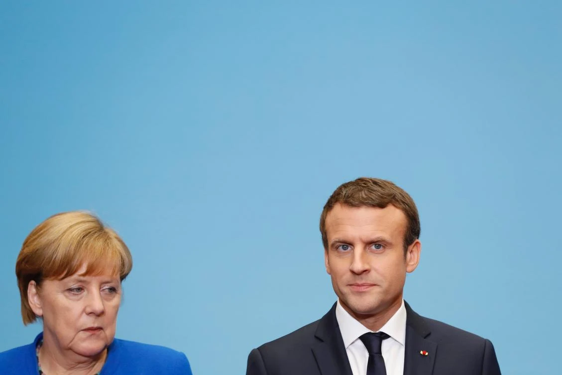 German Chancellor Angela Merkel (L) and French President Emmanuel Macron deliver a joint press conference at the Elysee Palace in Paris on July 13, 2017, during an annual Franco-German Summit. (AFP)