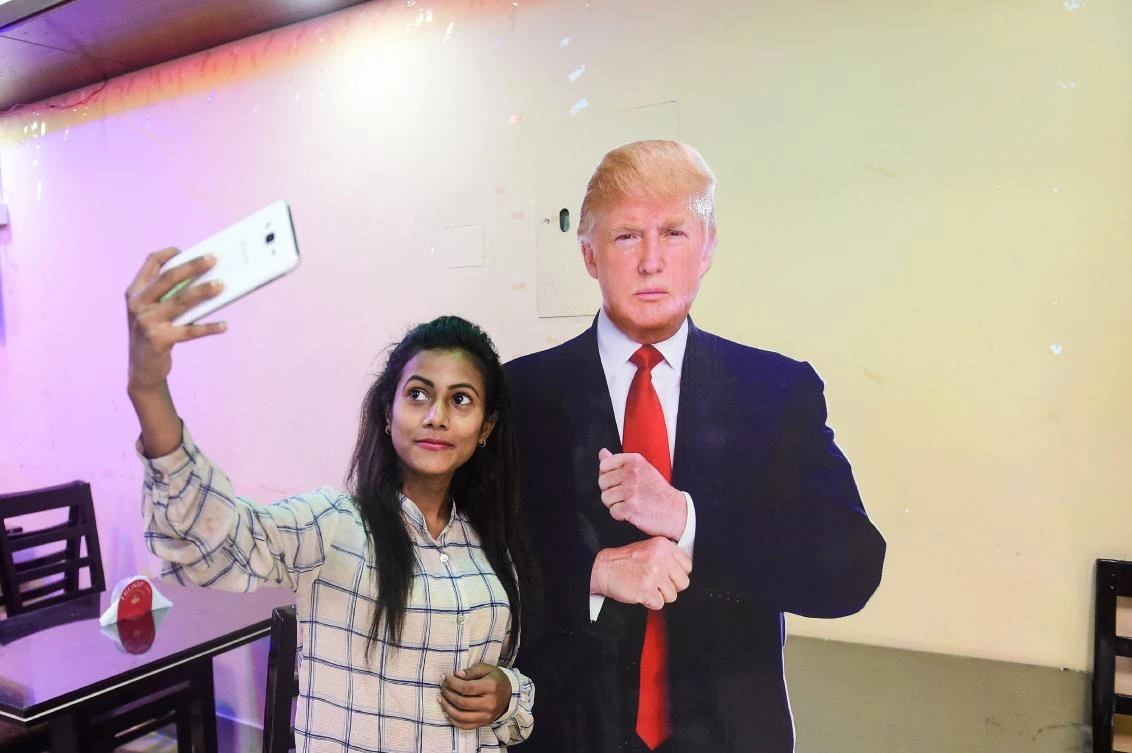 A Bangladeshi customer takes selfie with a cutout US President Donald Trump at the Trump Cafe in Dhaka on July 13, 2017. (AFP)