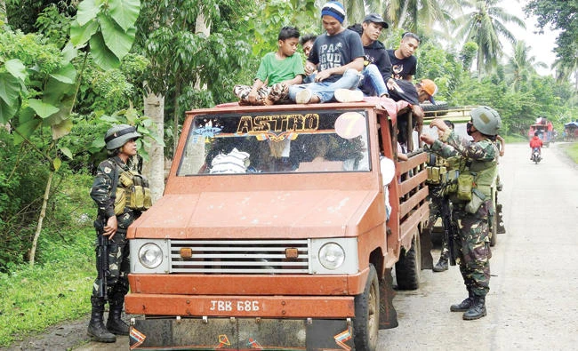 Soldiers inspect a passenger vehicle at a checkpoint in Jolo, Sulu, on the southern Philippine Island of Mindanao on Sunday. (AFP)