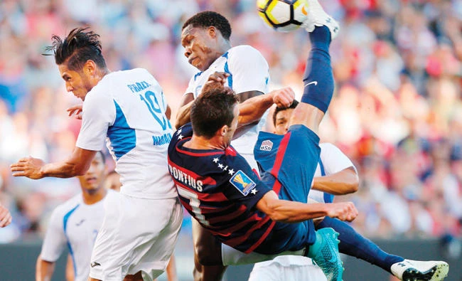 Chris Pontius of the US, front, shoots as Nicaragua players defend during the first half of a CONCACAF Gold Cup soccer match on Saturday. (AFP)