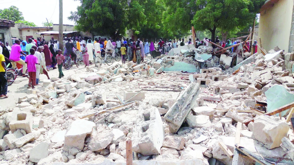 People gather at the site of a suicide bomb attack in Maiduguri, Nigeria, on Monday. (AP)
