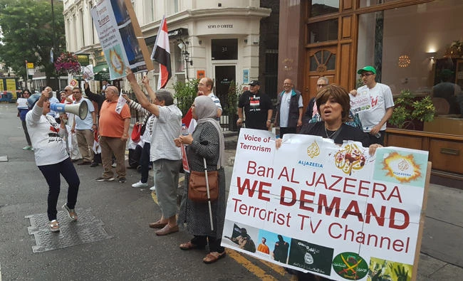 Protesters calling for the closure of ‘terror-supporting' Qatari network Al Jazeera gather on Monday outside the Frontline Club in London, where a panel discussion on Al Jazeera’s future was held. (Arab News photo)